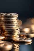 Stack of golden coins on dark background with bokeh lights, macro shot showing metallic texture and reflective surfaces for financial concepts.