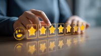 Customer satisfaction rating with golden stars and happy face emoji arranged in row on dark surface with reflection, showing positive feedback and service quality.