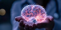 Glowing pink holographic brain floating above open palms against dark background, representing artificial intelligence, innovation and future technology concepts.