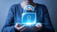 Professional woman holding glowing digital padlock icon representing cybersecurity, data protection and privacy technology solutions for business.