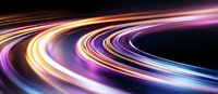 Curved light trails in motion creating dynamic streaks of orange, purple, and blue colors against dark background, abstract long exposure effect for technology concepts.