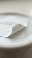 Clear transparent cosmetic gel texture in white bowl with smooth flowing consistency for skincare and beauty product applications.