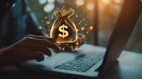 Digital money bag with dollar sign floating over laptop keyboard with magical glowing particles and hand silhouette in dark office setting, financial concept.