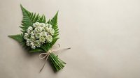 Small white flower bouquet with green fern leaves tied with natural twine on beige background. Minimalist floral arrangement for wedding decor and greeting cards.