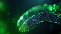 Glowing green particle wave with bokeh effect creates futuristic abstract curve against dark background, suitable for technology and science concepts.