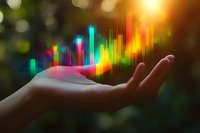 Glowing multicolored sound wave or financial chart floating above open palm against dark background with bokeh lights, representing digital transformation and data analysis.