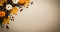 Autumn harvest composition with orange and white pumpkins, golden maple leaves, pine cones and acorns arranged on neutral background with copy space.