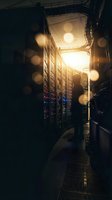 Server room corridor with illuminated equipment racks and warm golden light streaming through overhead panels, suitable for technology, data center, and IT infrastructure concepts.