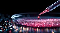Dramatic macro shot of pink liquid droplet falling from pipette into petri dish with sparkling solution against dark background with bokeh effect.