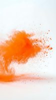 Vibrant orange powder explosion dispersing in air against white background, creating dynamic motion and particles for creative design projects.
