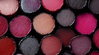 Colorful lipstick collection in various shades from nude to deep purple arranged in circular pattern for beauty and cosmetics industry use.