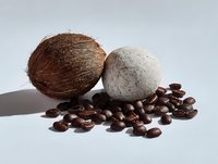 Whole coconut and dried coconut with coffee beans on white background, natural tropical ingredients for food and cosmetics.