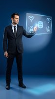 Professional businessman in dark suit interacting with holographic cybersecurity interface displaying network protection icons and wireless connectivity symbols.