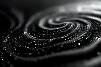 Mesmerizing spiral pattern of glowing particles in motion creates abstract black and white cosmic swirl with bokeh light effects and depth of field.