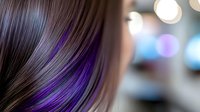 Young Asian woman with long straight dark brown hair featuring vibrant purple highlights and balayage effect against blurred bokeh background.