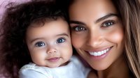 Young Hispanic mother and mixed race baby with blue eyes share tender moment together, close up portrait showing genuine smiles and loving bond between parent and child.