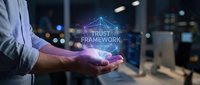 Businessman holding glowing digital trust and security hologram with network connections in modern office environment for technology concepts.