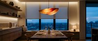 Modern luxury dining room with wooden table set for dinner, pendant lighting and panoramic city skyline view through floor-to-ceiling windows at dusk.