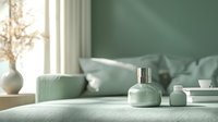 Minimalist sage green bedroom interior with sunlight, decorative vase and perfume bottle on textured bedding, creating serene morning atmosphere.