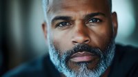 Professional African American businessman with gray beard in corporate office environment for business leadership and executive concepts.