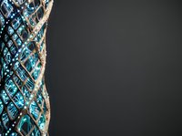 Fishing net with turquoise and white rope isolated on dark background, ready for maritime, nautical design, commercial fishing, or coastal themed projects.