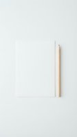 Blank white notebook with natural wood pencil on neutral background, suitable for education, creativity, writing projects, and office design concepts.