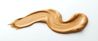 Foundation makeup smear in warm beige tone isolated on white background. Cosmetic product texture swatch for beauty and skincare applications.