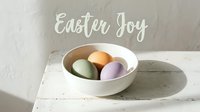 Pastel Easter eggs in a white ceramic bowl on a rustic wooden surface with Easter Joy text, soft natural light, spring holiday concept.