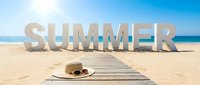 Large white Summer letters on sunny sandy beach with straw hat and sunglasses on wooden path, blue ocean and sky background.