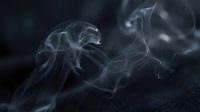 Ethereal white smoke swirls and wisps floating against dark background creating mystical atmospheric effect for creative design projects.