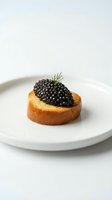 Gourmet canapé with black caviar and fresh dill garnish served on toasted bread round, plated on white ceramic dish for fine dining and upscale culinary presentations.