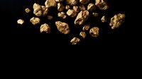 Golden nuggets scattered on black background for mining industry presentations and wealth concept designs.
