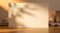 Blank paper card with natural shadow overlay on wooden surface creating warm aesthetic mockup for branding and design presentations.
