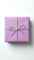 Lavender wrapped gift box with silver twine bow, isolated on white background, top view. Minimalist holiday present for celebration concepts.
