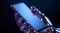 Futuristic smartphone held by robotic metallic hands with glowing blue neon lights against dark background, showcasing advanced technology and artificial intelligence concept.