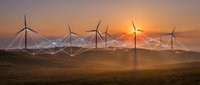 Wind turbines generating clean energy at sunset with digital network connections representing smart grid technology and sustainable power infrastructure.