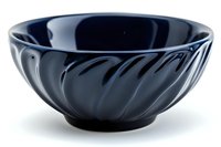 Elegant black ceramic bowl with spiral pattern design on glossy surface against white background, isolated for commercial and editorial use.