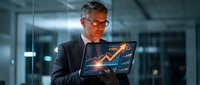 Middle-aged Caucasian businessman with glasses analyzing holographic financial data charts and graphs on futuristic transparent display in modern office.