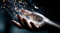 Open hand holding magical glowing particles and stardust with sparkling light effects on dark background for fantasy and wonder concepts.