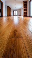 Empty modern room interior with polished hardwood flooring, built-in wooden shelving, and glass door entrance, showcasing natural light and clean architectural lines.