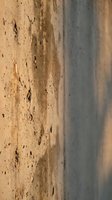 Weathered concrete wall surface with peeling paint and cracks showing natural aging and deterioration patterns for industrial design projects.