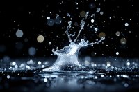 Dynamic water splash captured in dark setting with bokeh light effects and droplets creating artistic shape against black background with reflection.