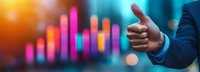 Business professional showing thumbs up gesture against colorful financial chart background with glowing bars and bokeh lights, indicating success and growth.