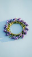 Purple grape hyacinth flowers arranged in circular wreath with green stems on soft blue background for spring decoration and floral design projects.