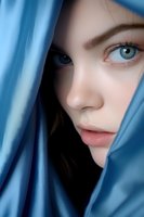 Close-up portrait of a young woman with bright blue eyes partially hidden behind silky blue fabric, creating an intimate and mysterious atmosphere. Soft lighting enhances natural beauty.