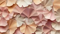 Delicate ginkgo leaves in soft pastel shades of pink, peach and cream create an elegant natural pattern. Gentle textured surface with overlapping botanical forms.