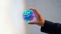 Businessman holding glowing digital coin with circuit board patterns and neon lights representing cryptocurrency blockchain technology and future finance.