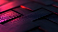 Geometric pattern of dark textured blocks illuminated by vibrant pink and red lighting creating dramatic shadows and depth effect for modern tech backgrounds.