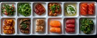 Fresh seafood and meat appetizers arranged in white ceramic compartments, including salmon sashimi, tuna, grilled chicken, beef, and seasoned vegetables served as restaurant starters.