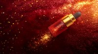 Luxurious red serum bottle with gold cap floating in cosmic red and gold glitter explosion against dark background, beauty product photography for cosmetics.